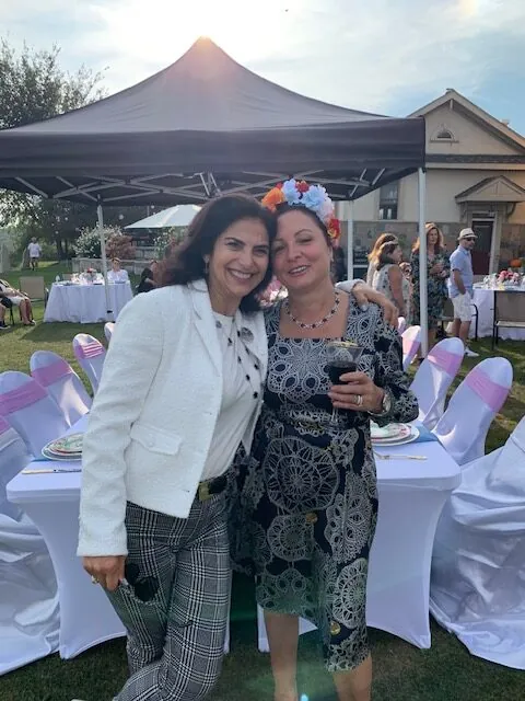 Arielle with a guest at an evening celebration