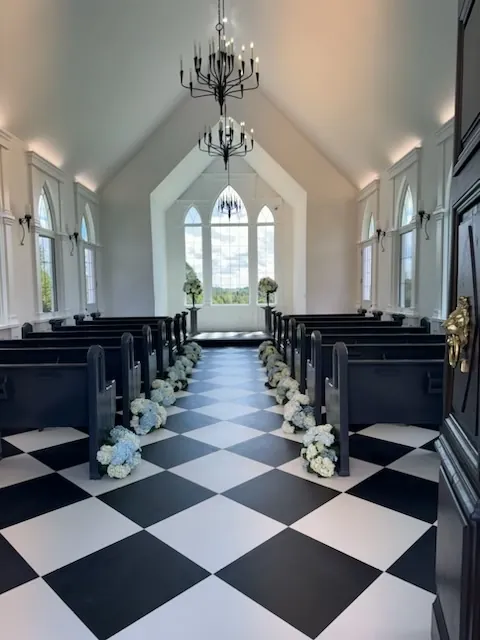 Inside the estate chapel, with white flowers along the aisle
