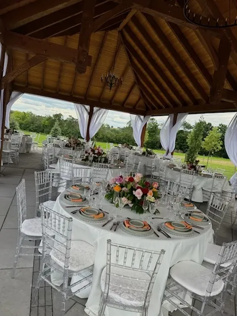A dinner table set under the garden pavilion